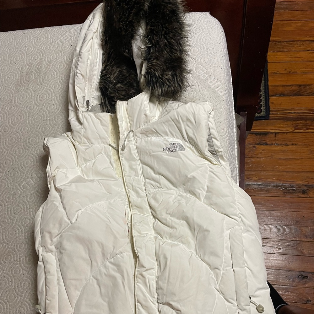 Women’s size lrg winter white North Face Vest with detachable fur hood.